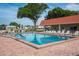 Community pool surrounded by lounge chairs offering a relaxing spot for residents at 1610 Reynolds Rd # 242, Lakeland, FL 33801
