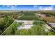 Stunning aerial view of a farm with fields and tree coverage featuring a home and pool within a defined boundary at 1646 Tyner Rd, Haines City, FL 33844