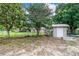 Fenced backyard with a storage shed and access to the other areas of the property at 1646 Tyner Rd, Haines City, FL 33844