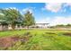 Fenced in backyard with equipment and vehicles stored under a large covered area at 1646 Tyner Rd, Haines City, FL 33844