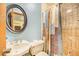Cozy bathroom featuring a shower and a pedestal sink in a classic design at 1646 Tyner Rd, Haines City, FL 33844