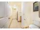 Spacious hallway with bathroom featuring accessible design and tile flooring at 1646 Tyner Rd, Haines City, FL 33844