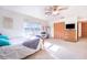 Bright bedroom with natural light, a ceiling fan, carpeted floors, closet, and a wooden dresser at 1646 Tyner Rd, Haines City, FL 33844
