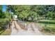 Gated driveway with mature trees offering privacy for the property at 1646 Tyner Rd, Haines City, FL 33844