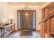 Inviting entryway features wood-look tile flooring, decor, and a solid front door with sidelights at 1646 Tyner Rd, Haines City, FL 33844
