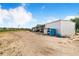 Exterior view of a large equipment storage building with multiple parking spaces and an open field at 1646 Tyner Rd, Haines City, FL 33844