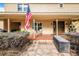 Inviting front porch with tile flooring, cozy seating, and an American flag at 1646 Tyner Rd, Haines City, FL 33844