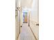 Hallway with neutral tile flooring and access to bathroom at 1646 Tyner Rd, Haines City, FL 33844