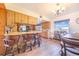 Open kitchen features a breakfast bar, wood cabinets, stainless appliances, and a cozy dining area at 1646 Tyner Rd, Haines City, FL 33844