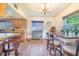 Bright eat-in kitchen features warm wood cabinetry and a dining area with natural light at 1646 Tyner Rd, Haines City, FL 33844