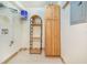 Functional laundry room featuring storage shelves and wood cabinet at 1646 Tyner Rd, Haines City, FL 33844