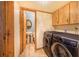 Laundry room with a modern washer and dryer, plus access to a half-bathroom with a pedestal sink at 1646 Tyner Rd, Haines City, FL 33844
