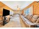 Spacious living room boasts wood paneling, a stone fireplace, and comfortable leather seating at 1646 Tyner Rd, Haines City, FL 33844