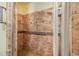 Walk-in shower featuring patterned tile and safety bar at 1646 Tyner Rd, Haines City, FL 33844