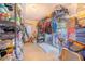 An organized storage room with shelves, hanging clothes, and a sliding glass door to the outside at 1646 Tyner Rd, Haines City, FL 33844