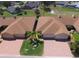 A residential home featuring a brick driveway, attached two-car garage, and surrounded by mature trees at 1674 Linz Ct, Winter Haven, FL 33884