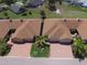 A residential home featuring a brick driveway, attached two-car garage, and surrounded by mature trees at 1674 Linz Ct, Winter Haven, FL 33884