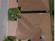 Overhead view of a home with a brick driveway, brown roof, and manicured landscaping at 1674 Linz Ct, Winter Haven, FL 33884