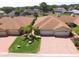 A residential home featuring a brick driveway, attached two-car garage, and surrounded by mature trees at 1674 Linz Ct, Winter Haven, FL 33884