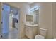 Cozy bathroom features a toilet, sink, vanity with a mirror, and light fixture at 1674 Linz Ct, Winter Haven, FL 33884