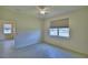 Bedroom featuring tile floors, a ceiling fan, and a window overlooking the backyard at 1674 Linz Ct, Winter Haven, FL 33884
