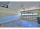 View of an empty two car garage with door and a trash container at 1674 Linz Ct, Winter Haven, FL 33884