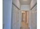 Hallway view with multiple closets and neutral walls and flooring at 1674 Linz Ct, Winter Haven, FL 33884