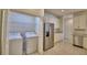 Open kitchen with stainless steel appliances, granite counters, and a laundry closet at 1674 Linz Ct, Winter Haven, FL 33884