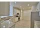Bright kitchen with stainless steel appliances, granite counters, and recessed lighting at 1674 Linz Ct, Winter Haven, FL 33884