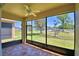 Screened lanai with tile floors, fan and views of backyard and mature landscaping at 1674 Linz Ct, Winter Haven, FL 33884