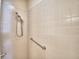 Walk-in shower with handrails and tiled walls at 1674 Linz Ct, Winter Haven, FL 33884