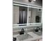 Modern bathroom mirror with integrated lighting, double sinks, and sleek black hardware at 1681 Waterview Loop, Haines City, FL 33844