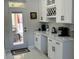 Bright kitchen area featuring a coffee bar, white cabinets, and a view to the outdoor seating area at 1681 Waterview Loop, Haines City, FL 33844