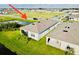 Aerial view of a house with a screened lanai near a pond, showing a full neighborhood at 1760 Carnostie Rd, Winter Haven, FL 33884