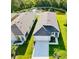 An aerial shot of several homes showing roof lines, driveways and landscaping at 1760 Carnostie Rd, Winter Haven, FL 33884