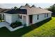 Side view of a home featuring a landscaped yard and attached one-car garage at 1760 Carnostie Rd, Winter Haven, FL 33884