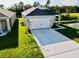Charming single-Gathering home with a well-manicured lawn and an attached one car garage at 1760 Carnostie Rd, Winter Haven, FL 33884