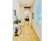 Inviting hallway featuring tile flooring, stylish decor, and an open view of the living area at 1760 Carnostie Rd, Winter Haven, FL 33884