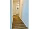 Hallway with wood floors and white doors at 1760 Carnostie Rd, Winter Haven, FL 33884