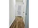 Hallway with wood floors and white doors at 1760 Carnostie Rd, Winter Haven, FL 33884