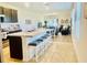 Open kitchen with large island, breakfast bar, and seating flowing into the living area at 1760 Carnostie Rd, Winter Haven, FL 33884