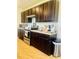 Gourmet kitchen with stainless appliances, dark wood cabinets, and ample counter space at 1760 Carnostie Rd, Winter Haven, FL 33884