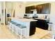 Kitchen with stainless steel appliances, dark wood cabinets, and bar stool seating at the island at 1760 Carnostie Rd, Winter Haven, FL 33884