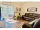 Bright living room featuring wood floors, leather furniture, and decor at 1760 Carnostie Rd, Winter Haven, FL 33884