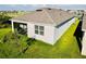 Lush green lawn surrounding a house with a screened in lanai, and multiple windows at 1760 Carnostie Rd, Winter Haven, FL 33884