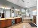 Elegant bathroom with dual sinks, a corner tub, a separate shower, and modern fixtures at 177 Costa Loop, Auburndale, FL 33823