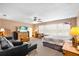 Spacious bedroom featuring neutral colored walls, large window, ceiling fan, and comfortable seating area at 177 Costa Loop, Auburndale, FL 33823