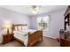 Bedroom featuring a wooden bedframe and furniture, soft lavender walls, and a bright window at 177 Costa Loop, Auburndale, FL 33823