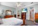 Relaxing bedroom featuring neutral tones, carpet flooring, ceiling fan, and a glimpse into the Primary bath at 177 Costa Loop, Auburndale, FL 33823