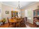 Traditional dining room showcasing hardwood floors, a chandelier, and classic wood furniture with natural light at 177 Costa Loop, Auburndale, FL 33823